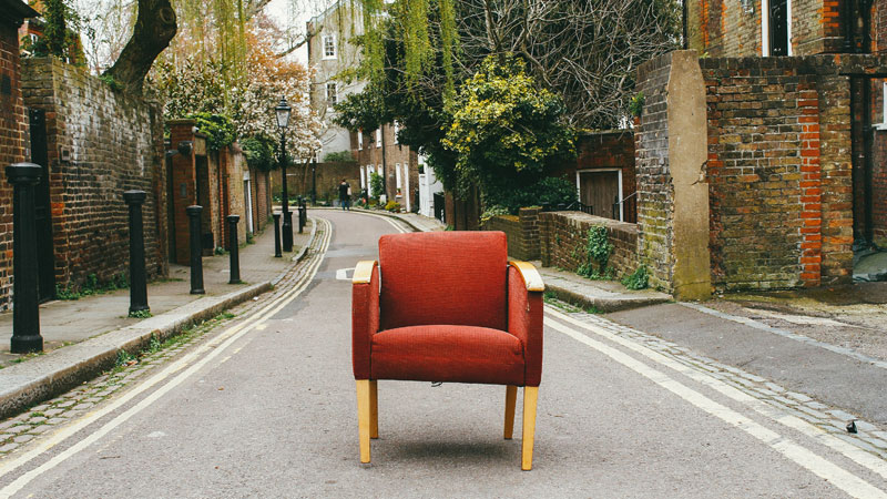A red chair in the middle of the road