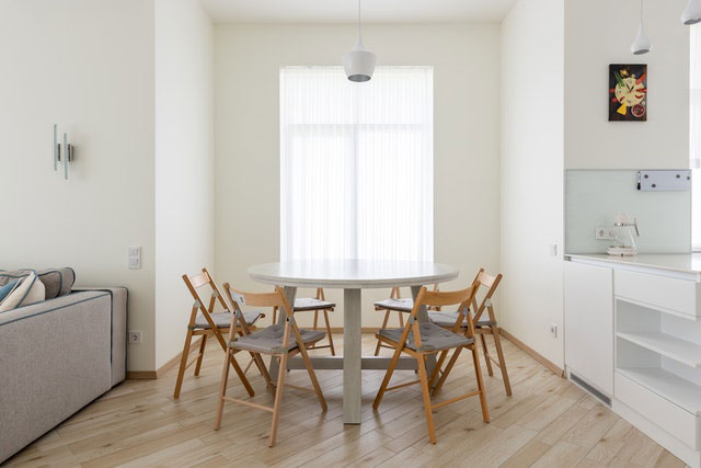 A round table with six chairs around it.